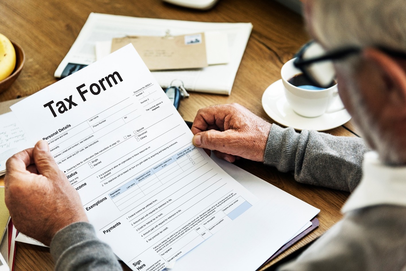 man holding tax form